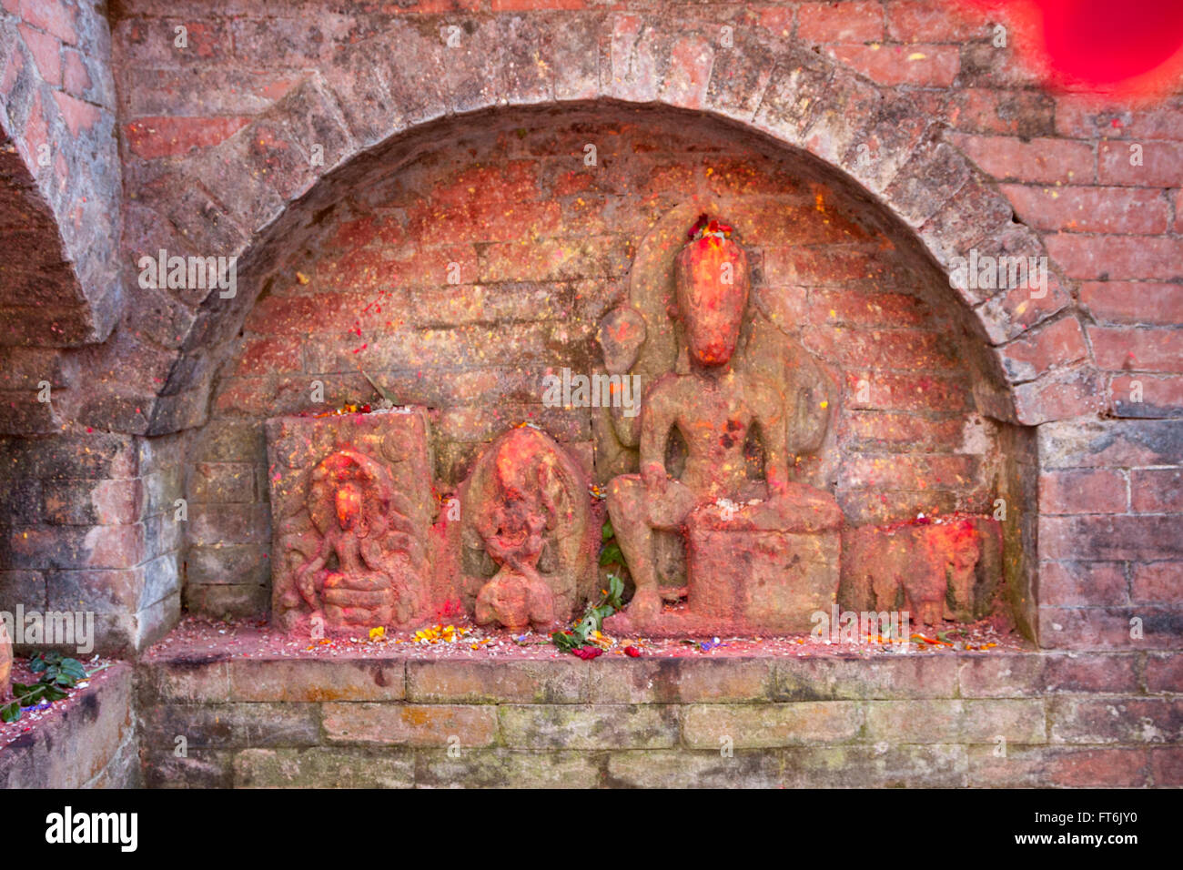 Nepal, Kathmandu.   Shrine Dated to the pre-Lichchhavi Period, probably 3rd. Century A.D.  Offerings of Rice and Flower Petals. Stock Photo