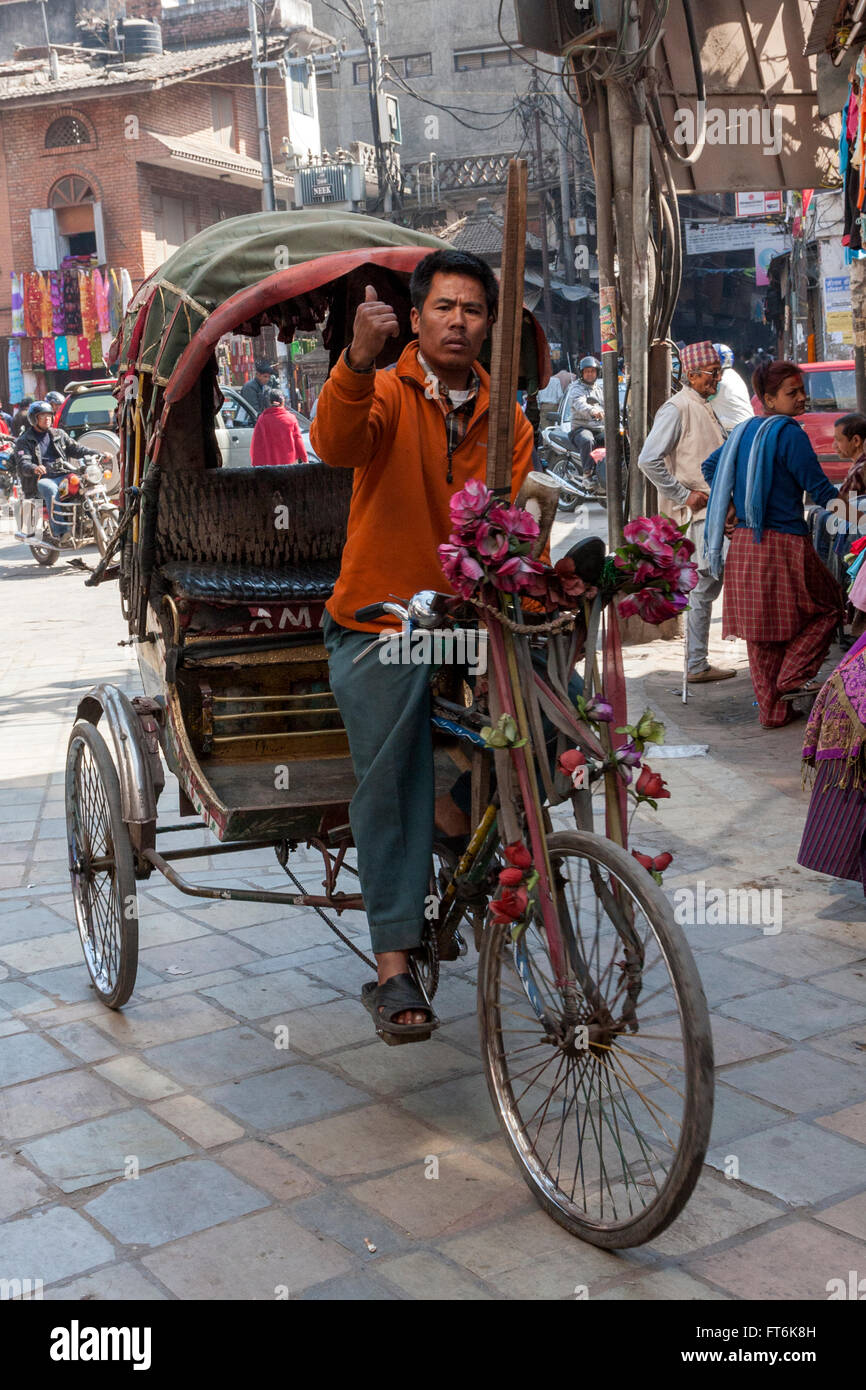 Nepal, Kathmandu.  Rickshaw Driver Looking for a Passenger. Stock Photo