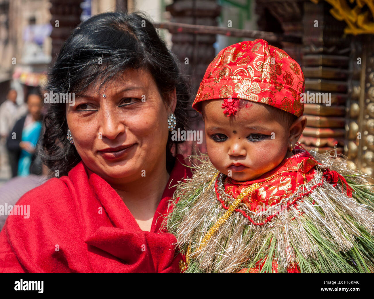 Nepal, Kathmandu.  Celebrating a six-month-old boy's eating rice for the first time, his family brings him to the temple. Stock Photo