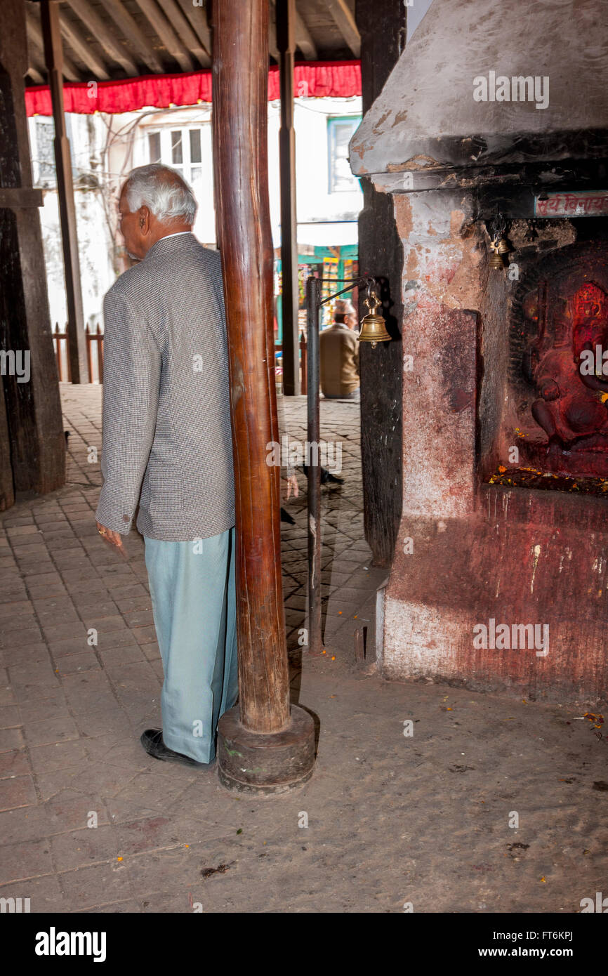 Nepal, Kathmandu. Hindu Man Rubbing his Back against a Pole in the