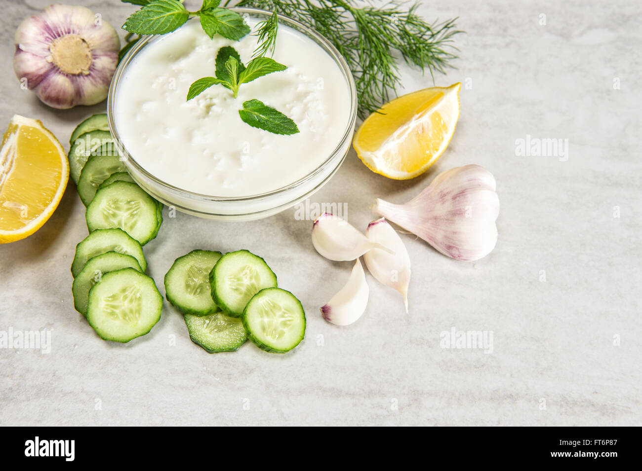 Tzatziki sauce with herbs and vegetables. Food background Stock Photo