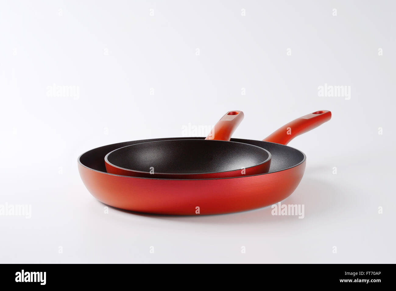 red frying pans with nonstick surface Stock Photo