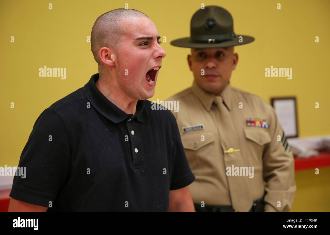 A US Marine Corps drill instructor screams at a Marine recruit during boot camp at Marine Corps Recruit Depot December 15, 2015 in San Diego, California. The depot is responsible for training more than 16,000 recruits annually. Stock Photo
