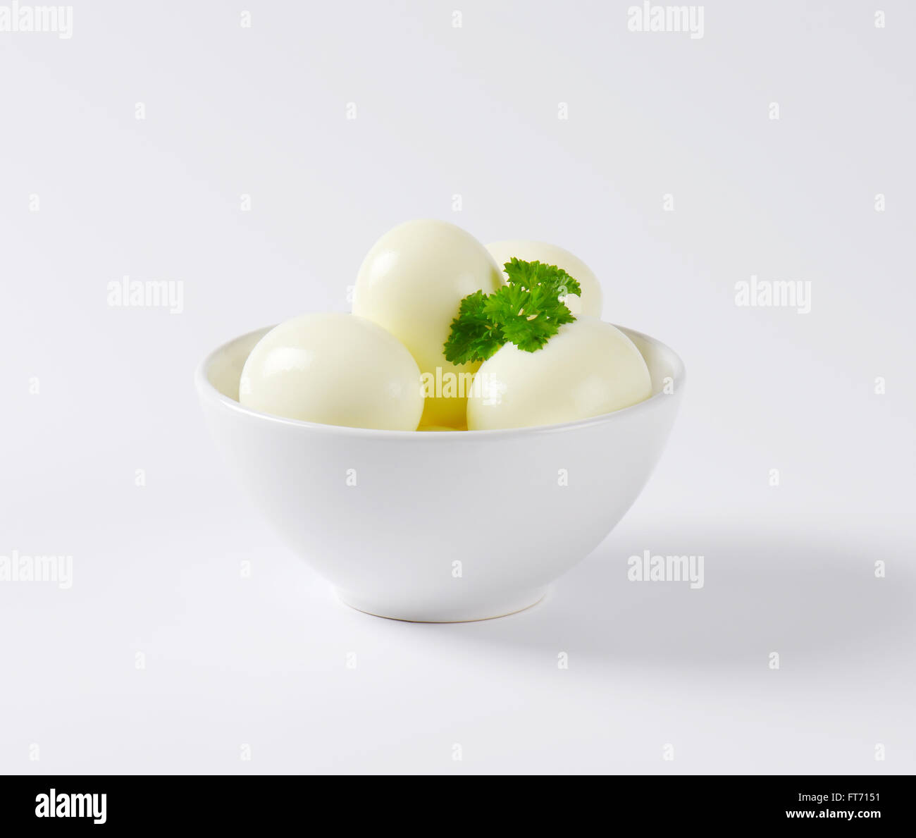 side view of bowl with peeled hard boiled eggs Stock Photo