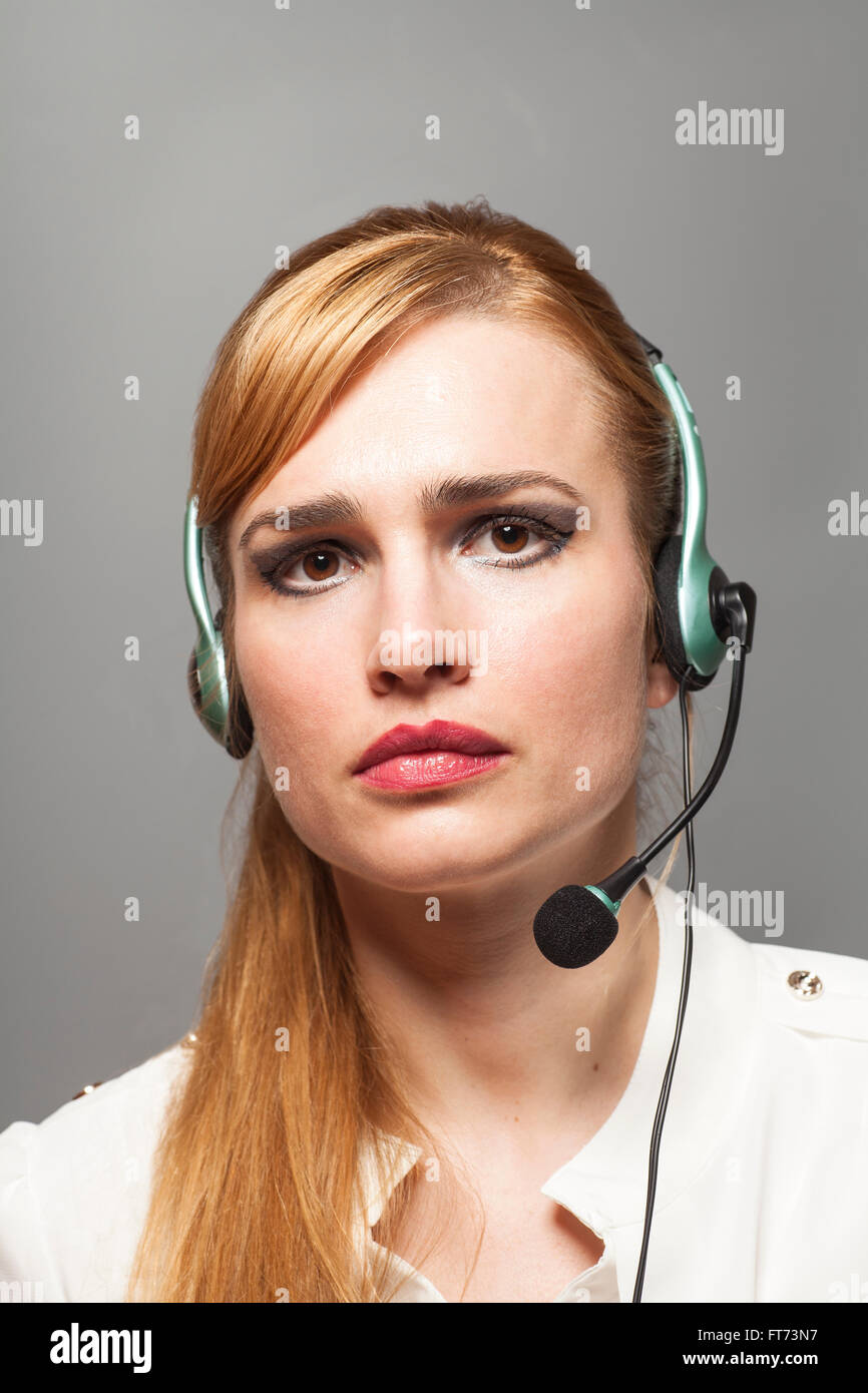 Support phone operator in headset isolated on gray background Stock
