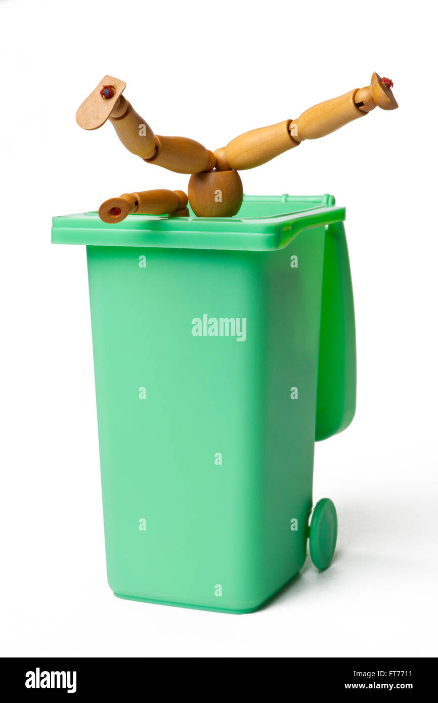 Garbage Can with a Wooden Figure Stock Photo