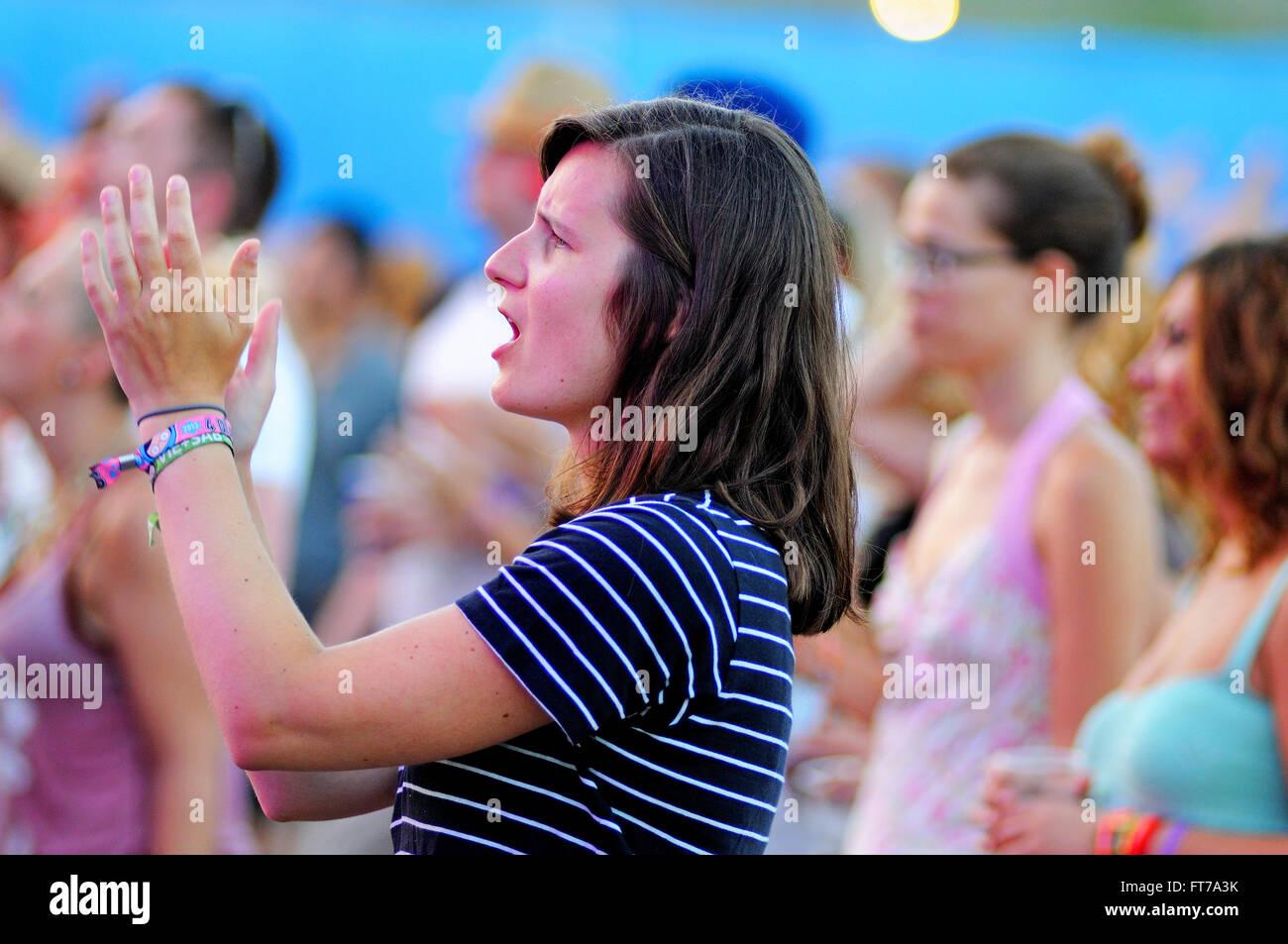 BENICASSIM, SPAIN - JULY 19: A woman from the crowd applauding at FIB (Festival Internacional de Benicassim) 2013 Festival. Stock Photo