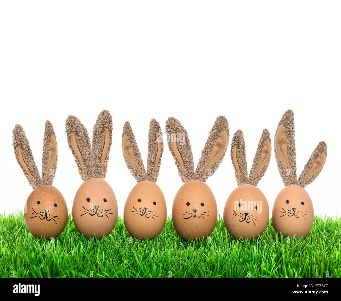 Cute smiling bunnies easter eggs with big ears. Funny holidays decoration Stock Photo