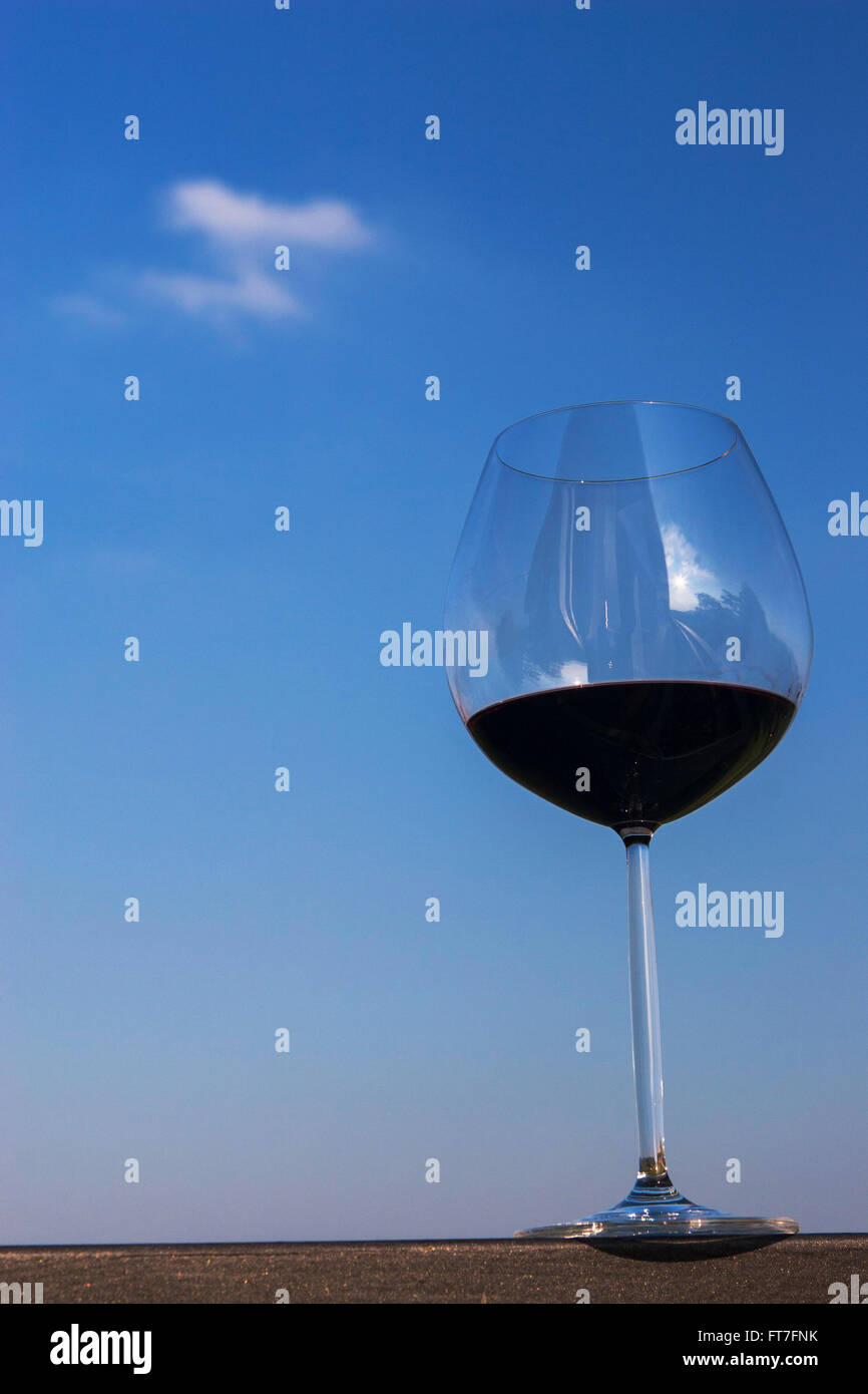 Glass of red wine with sky background Stock Photo