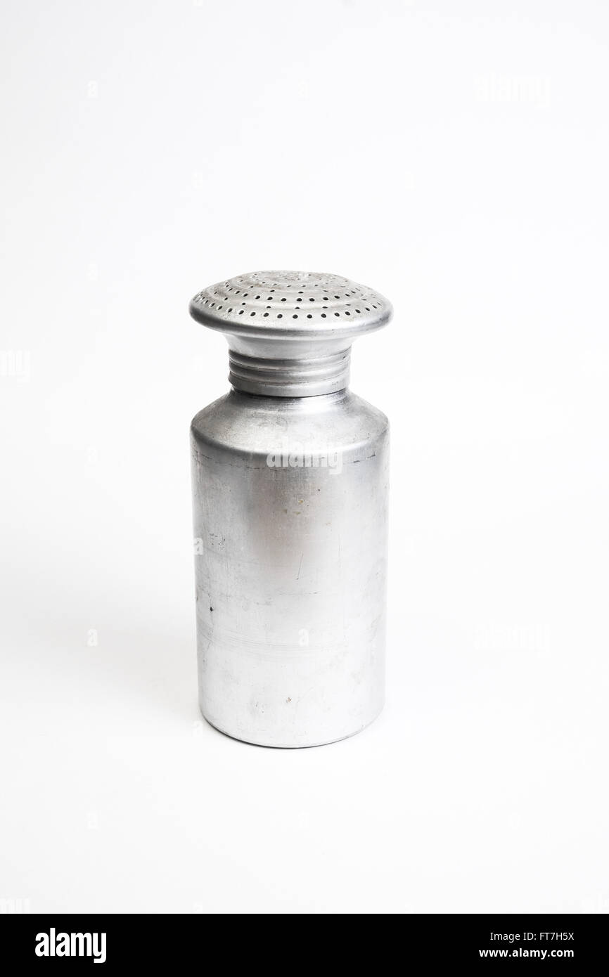 Aluminum saltshaker with the lid on, in front of a light background Stock Photo