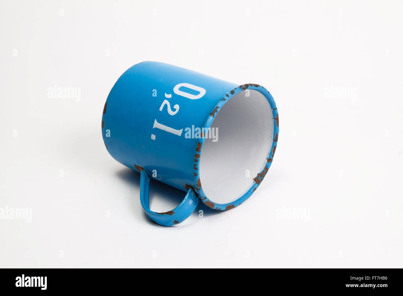 small blue vintage measuring cup lying on a white background Stock ...