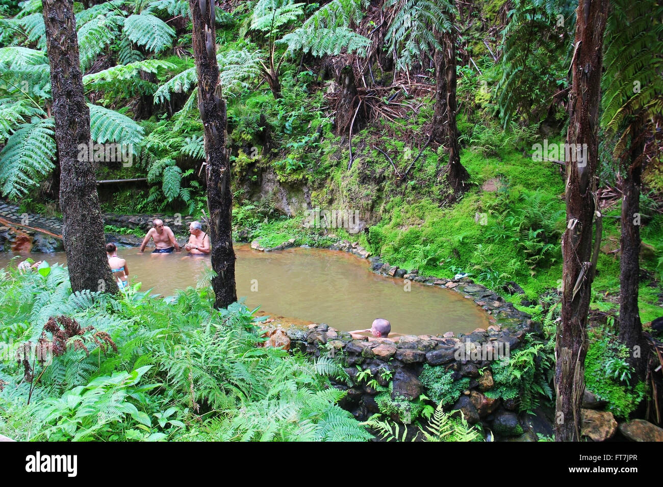 People enjoy bath in natural thermal pools of Caldeira Velha on Sao