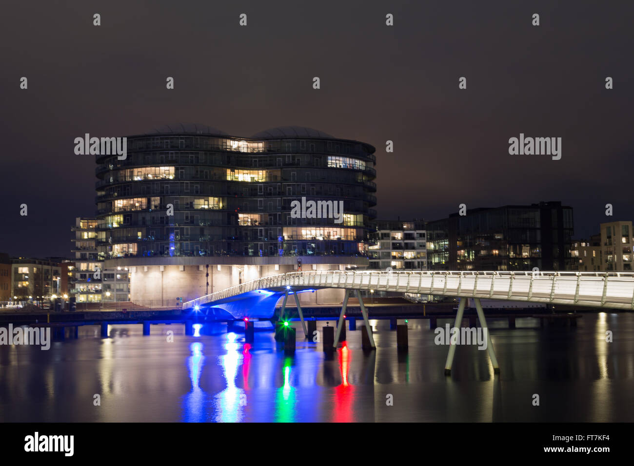 Copenhagen, Denmark - March 22, 2016: Modern cyclist and pedestrian bridge Bryggebroen and Gemini residence by night Stock Photo
