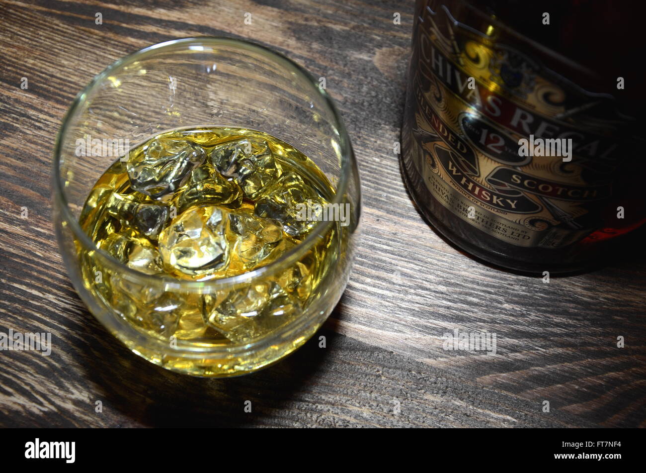 Glass of Chivas Regal whisky on wooden table Stock Photo - Alamy