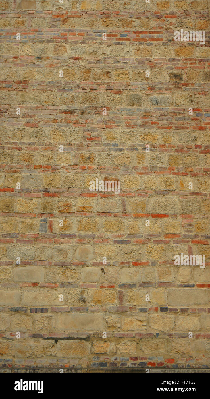 Texture of old wall of red bricks and stones in vertical format Stock Photo