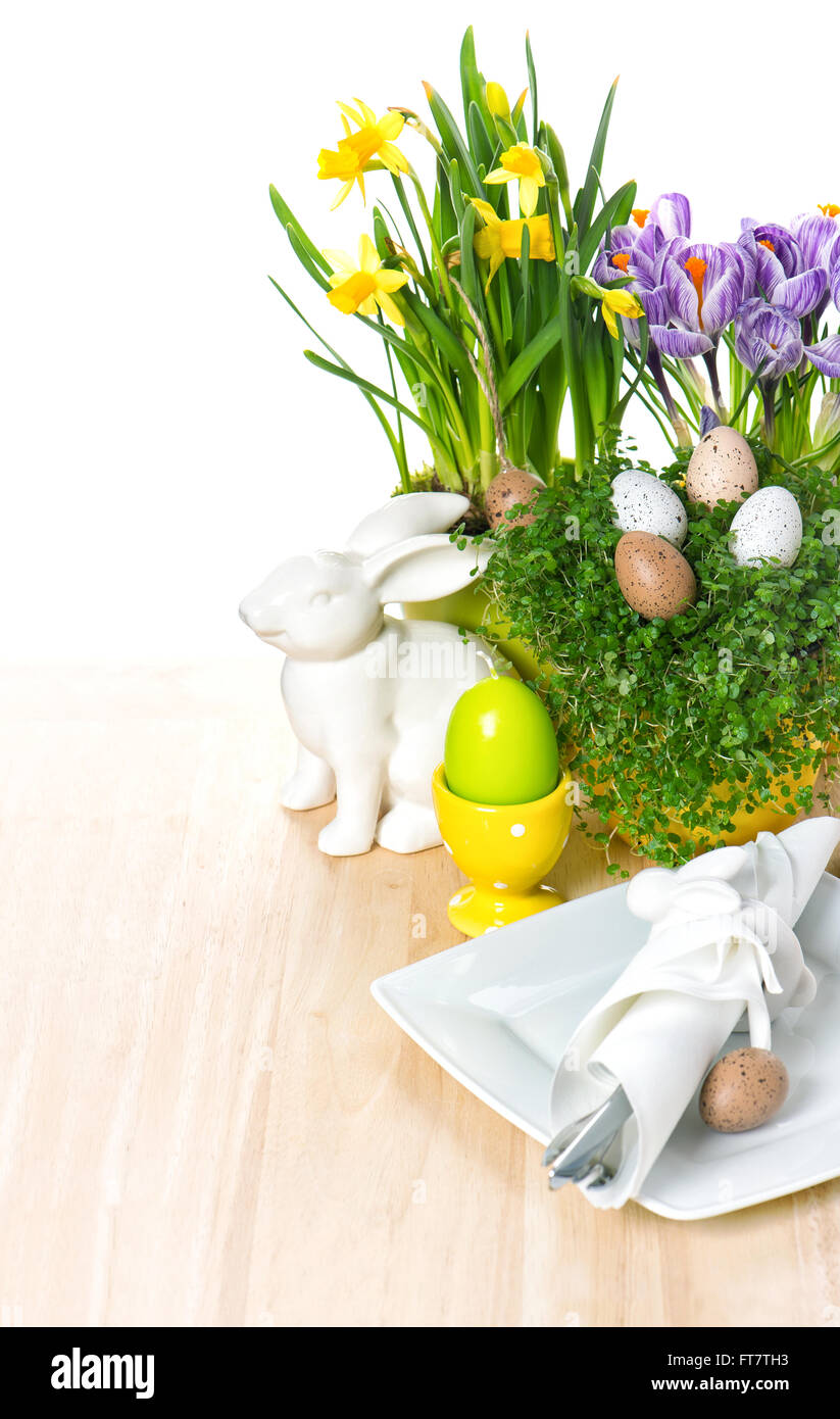 Easter table setting with flowers, bunny and eggs decoration on white ...