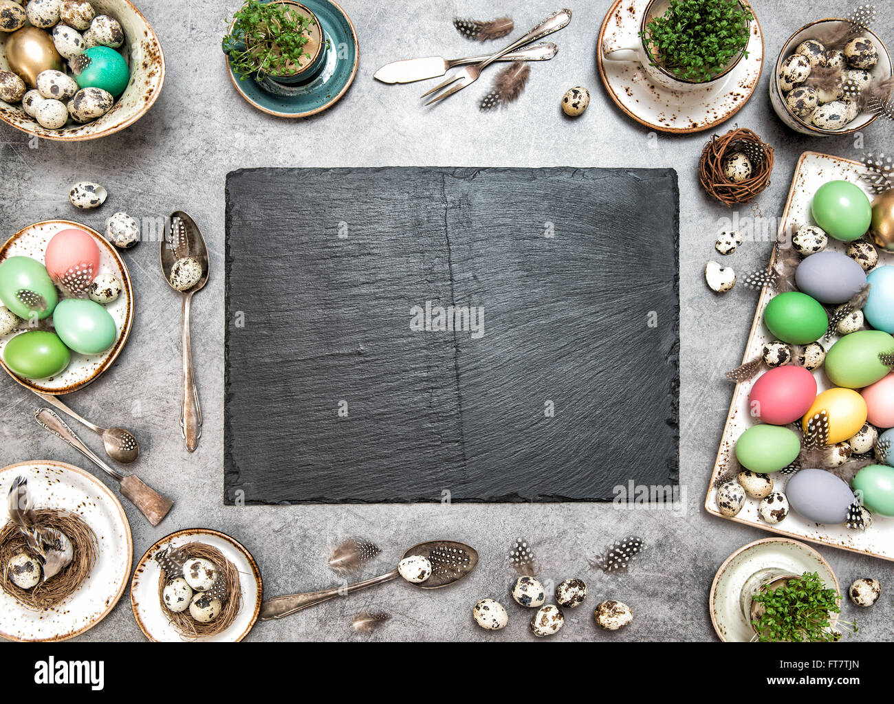 Easter table decoration with colorful eggs and slate plate for your ...