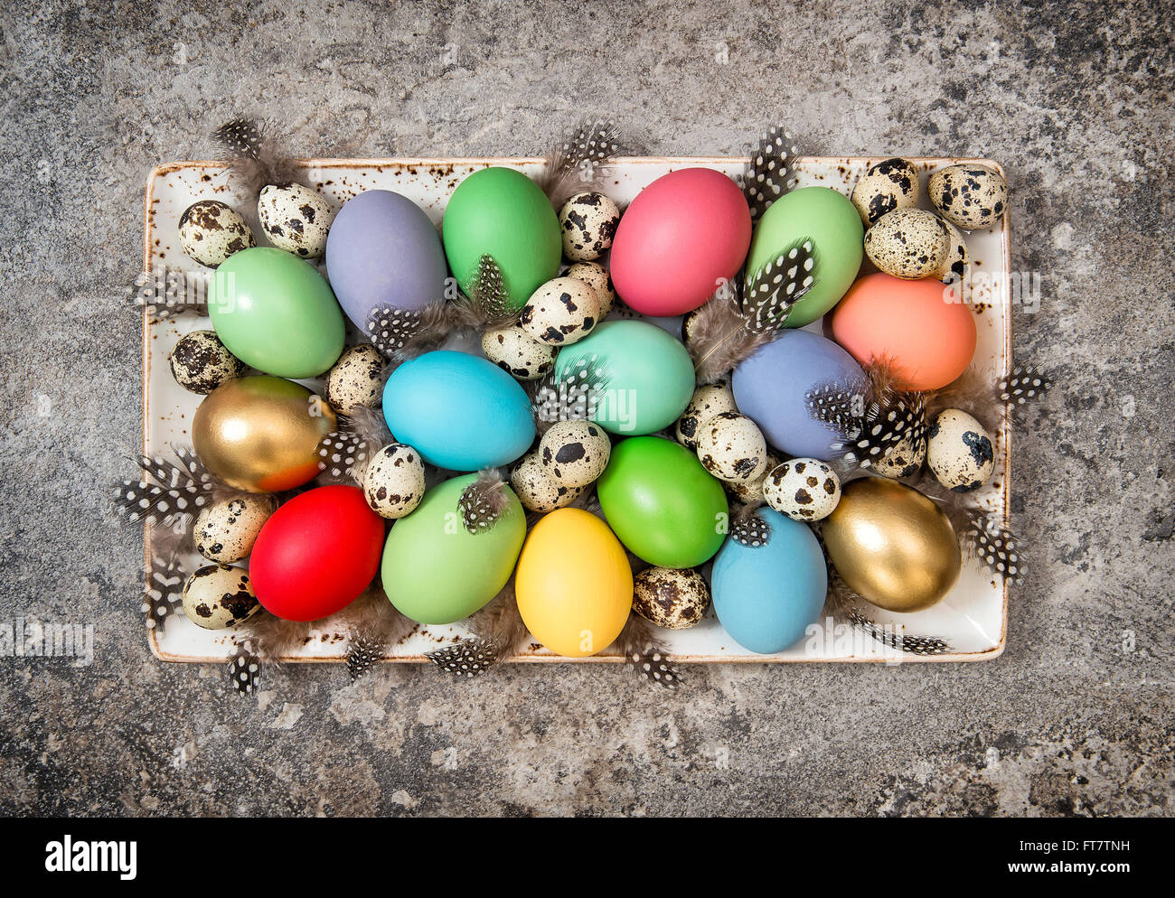 Easter eggs decoration on grey stone background. Vintage style dark toned picture Stock Photo