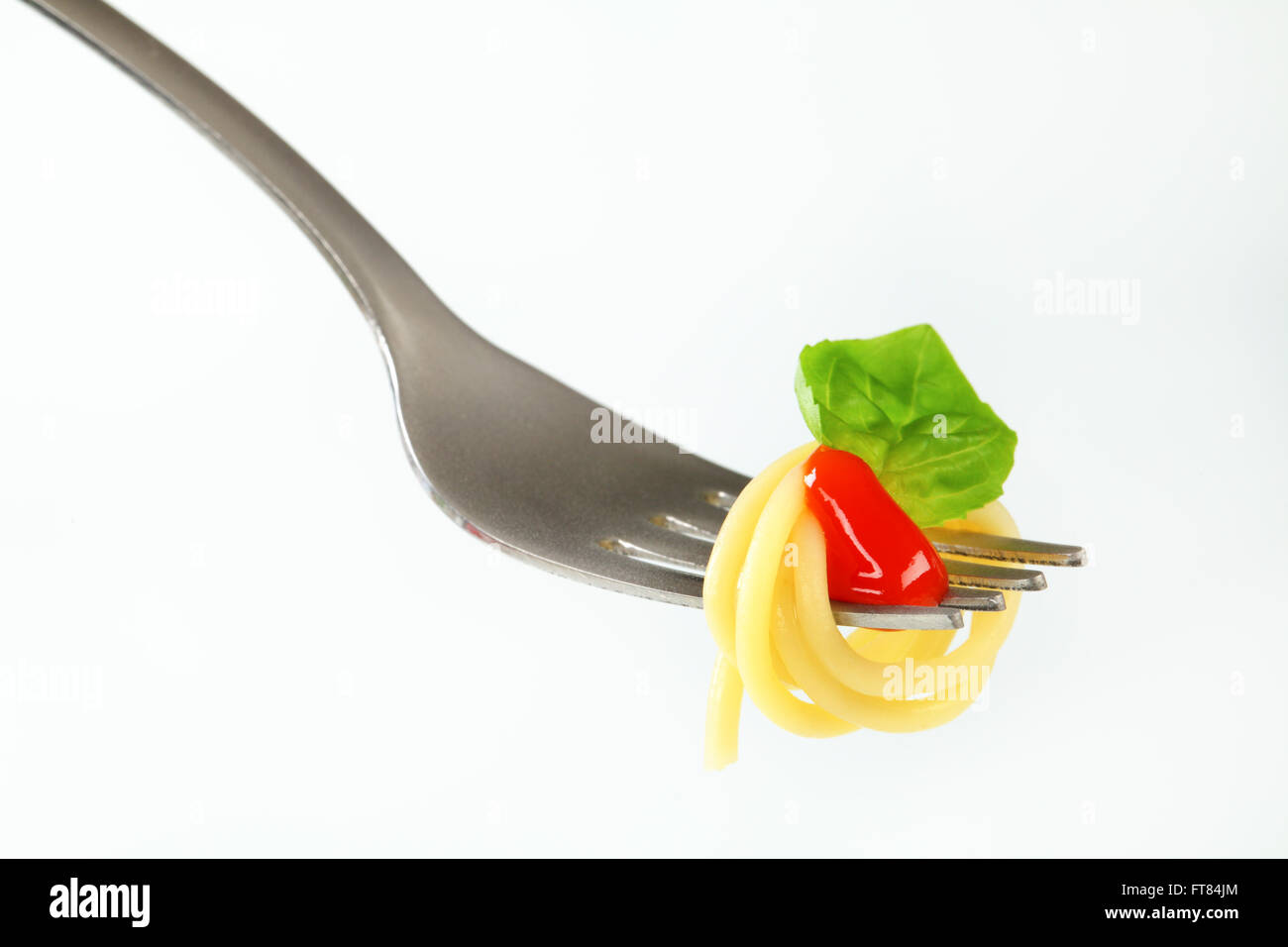 Spaghetti with ketchup twirled on fork Stock Photo