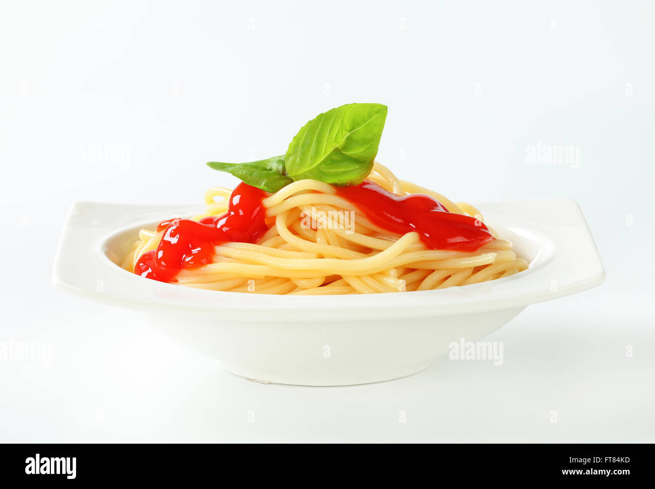 Portion of cooked spaghetti with ketchup Stock Photo