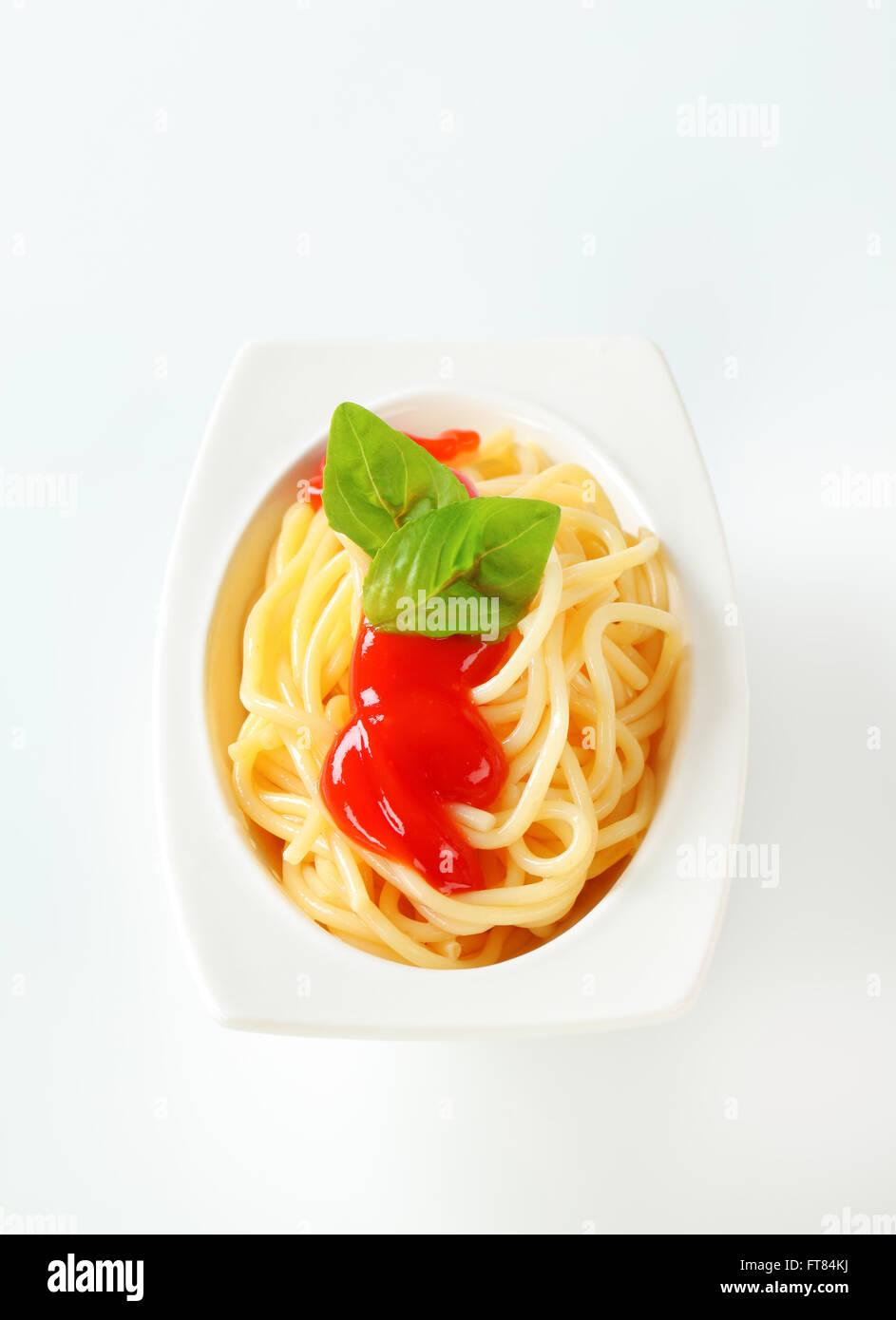 Portion of cooked spaghetti with ketchup Stock Photo