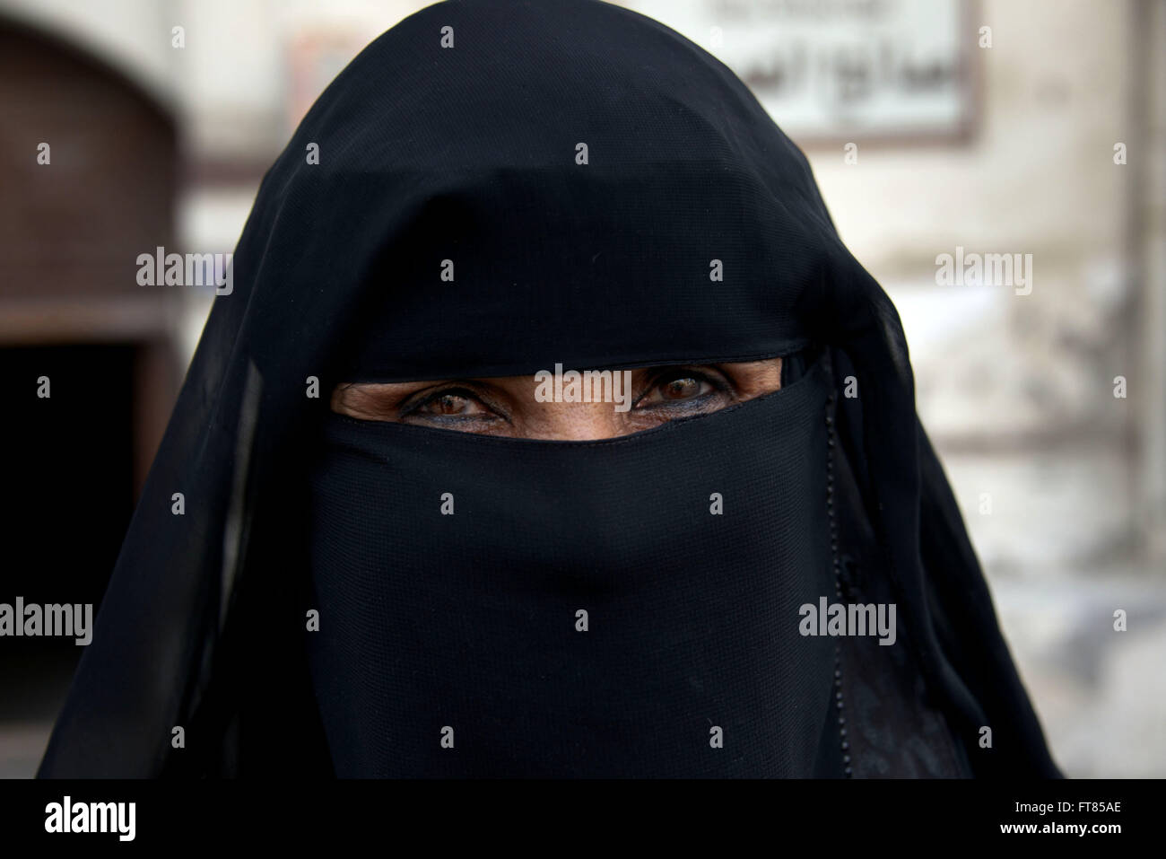 Saudi woman covered with black hijab and closeup of eyes Stock Photo