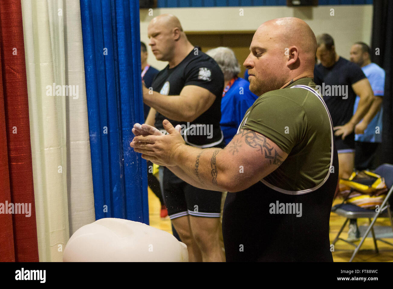 Border Patrol Agent Matt Phelps of Bonners Ferry Idaho chalks his hands  prior to attemping a World Record 551lbs at the World Police and Fire Games  in Herndon Virginia. Photo by James