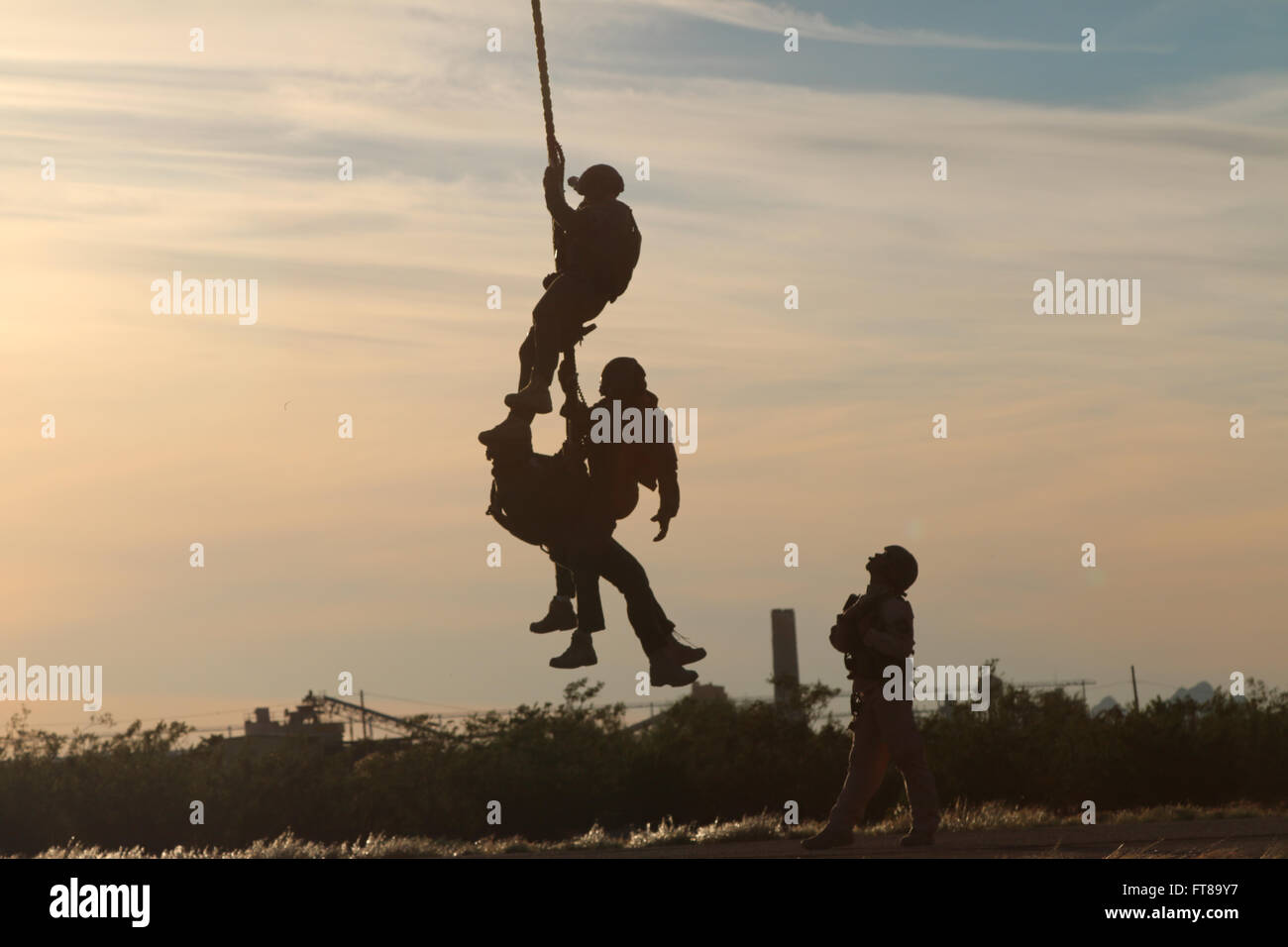 At Davis-Monthan Air Force Base, Air and Marine Operations collaborated with the Tucson Police Department SWAT team for joint fast rope training. This exercise demonstrates the coordination between military and law enforcement in specialized tactical operations. Stock Photo