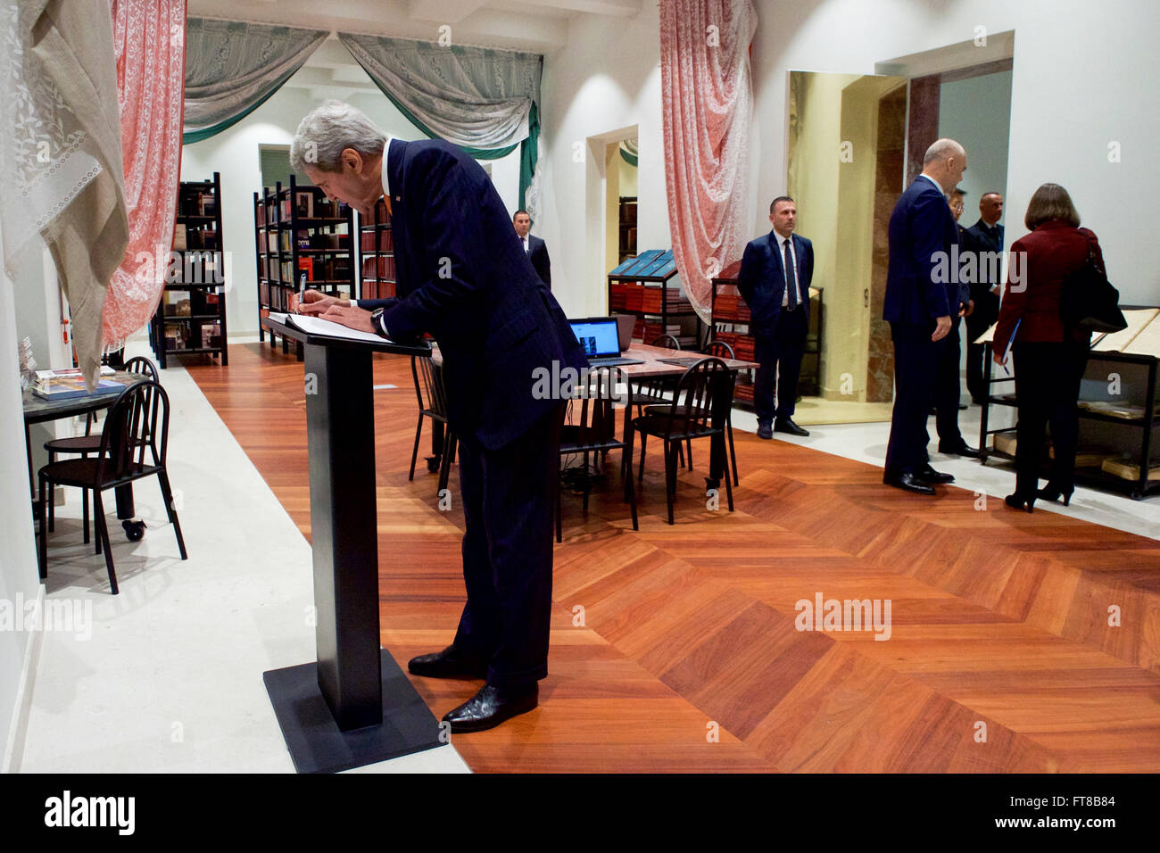 Albanian Prime Minister Edi Rama speaks with Assistant Secretary of State for European and Eurasian Affairs Toria Nuland as U.S. Secretary of State John Kerry signs the guestbook in a library open to the public on the first floor of the Prime Ministry in Tirana, Albania, following a bilateral meeting on February 14, 2016. [State Department Photo] Stock Photo