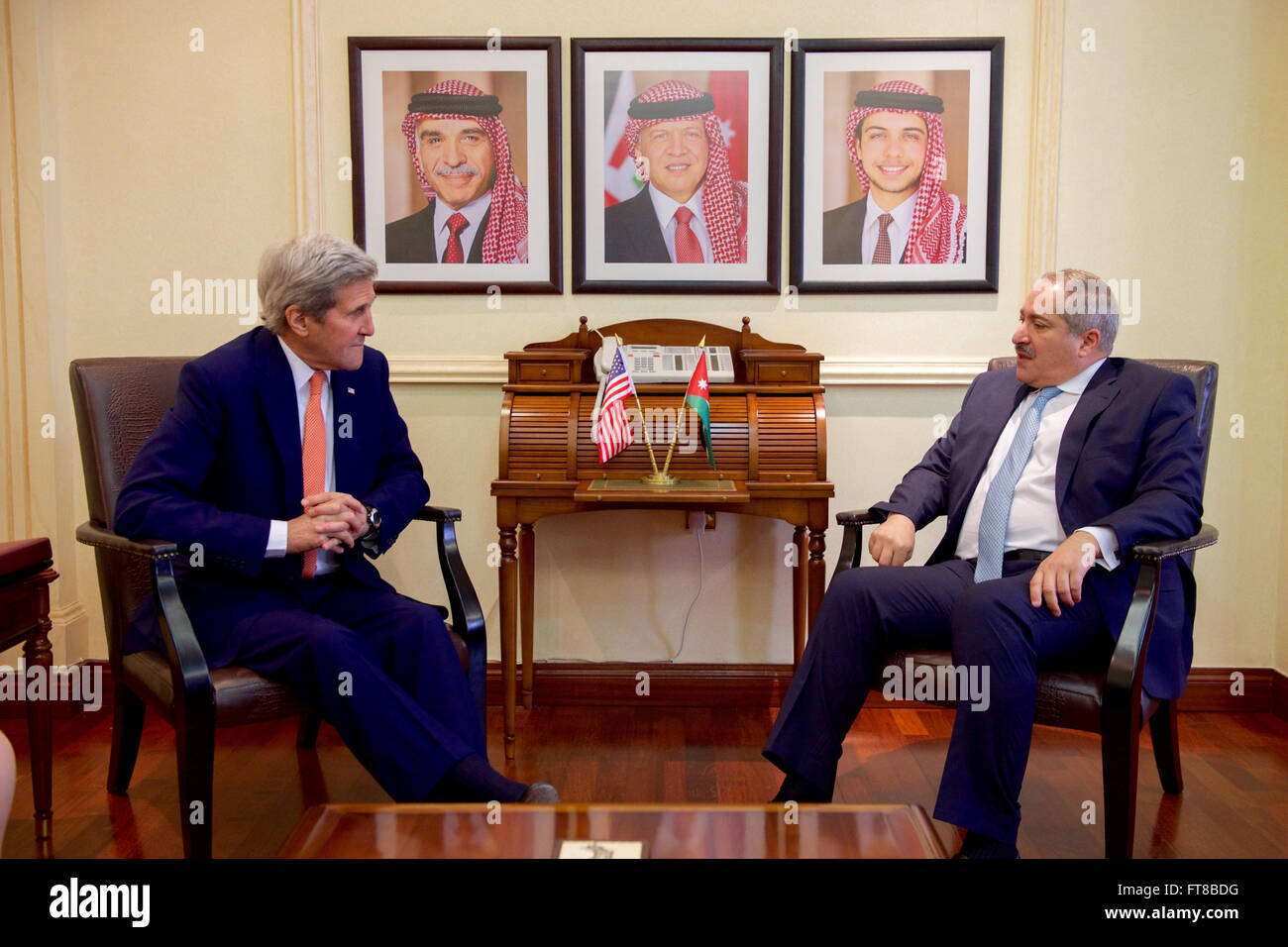 U.S. Secretary of State John Kerry sits with Jordanian Foreign Minister Nasser Judeh before a bilateral meeting on February 21, 2016, at the Jordanian Foreign Ministry of Foreign Affairs in Amman, Jordan. [State Department photo/ Public Domain] Stock Photo
