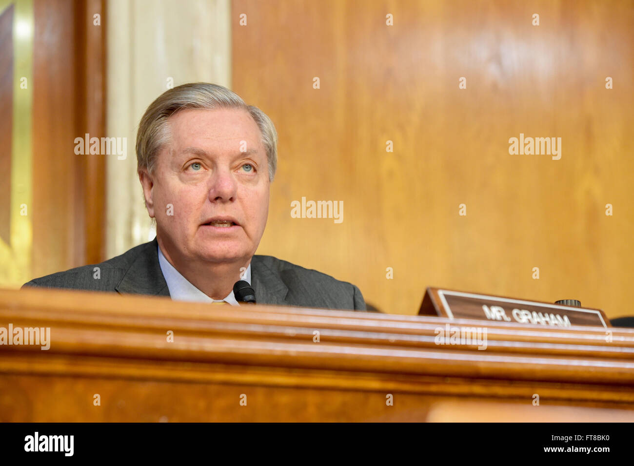 U.S. Senator Lindsey Graham of South Carolina addresses U.S Secretary of State John Kerry on February 24, 2016, as he prepares to testify before the Senate Appropriations Committee on Foreign Operations on Capitol Hill in Washington, D.C. [State Department photo/ Public Domain] Stock Photo