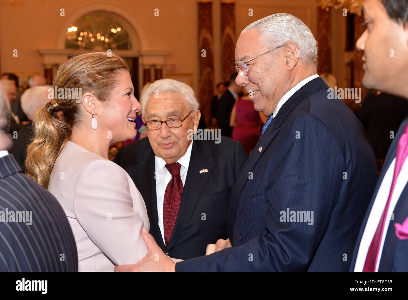 Former U.S. Secretaries of State Colin Powell and Henry Kissinger chat with Mrs. Sylvie Grégoire-Trudeau at the State Luncheon in honor of Canadian Prime Minister Justin Trudeau at the U.S. Department of State in Washington, D.C., on March 10, 2016. [State Department photo/ Public Domain] Stock Photo