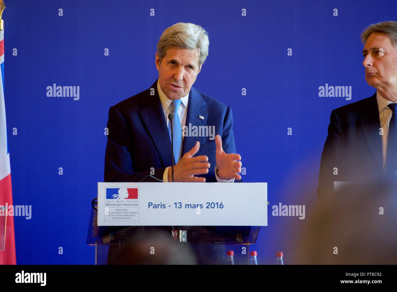 British Foreign Secretary Philip Hammond looks on as U.S. Secretary of State John Kerry addresses reporters on March 13, 2015, at the Quai d'Orsay in Paris, France, after they held an E4+1 meeting - including representatives of France, Germany, Italy, the United Kingdom, and European Union - focused on Syria, Libya, Yemen, Ukraine, and other foreign policy matters. [State Department Photo/Public Domain] Stock Photo