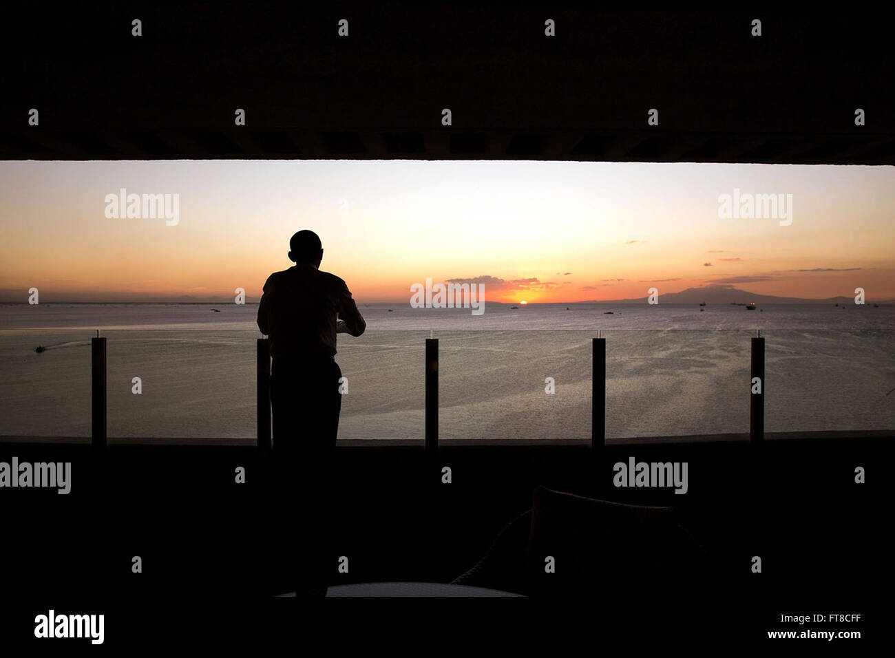 Nov. 19, 2015 'The President watches the sun set over Manila Bay from his hotel balcony in Manila.' (Official White House Photo by Pete Souza) Stock Photo