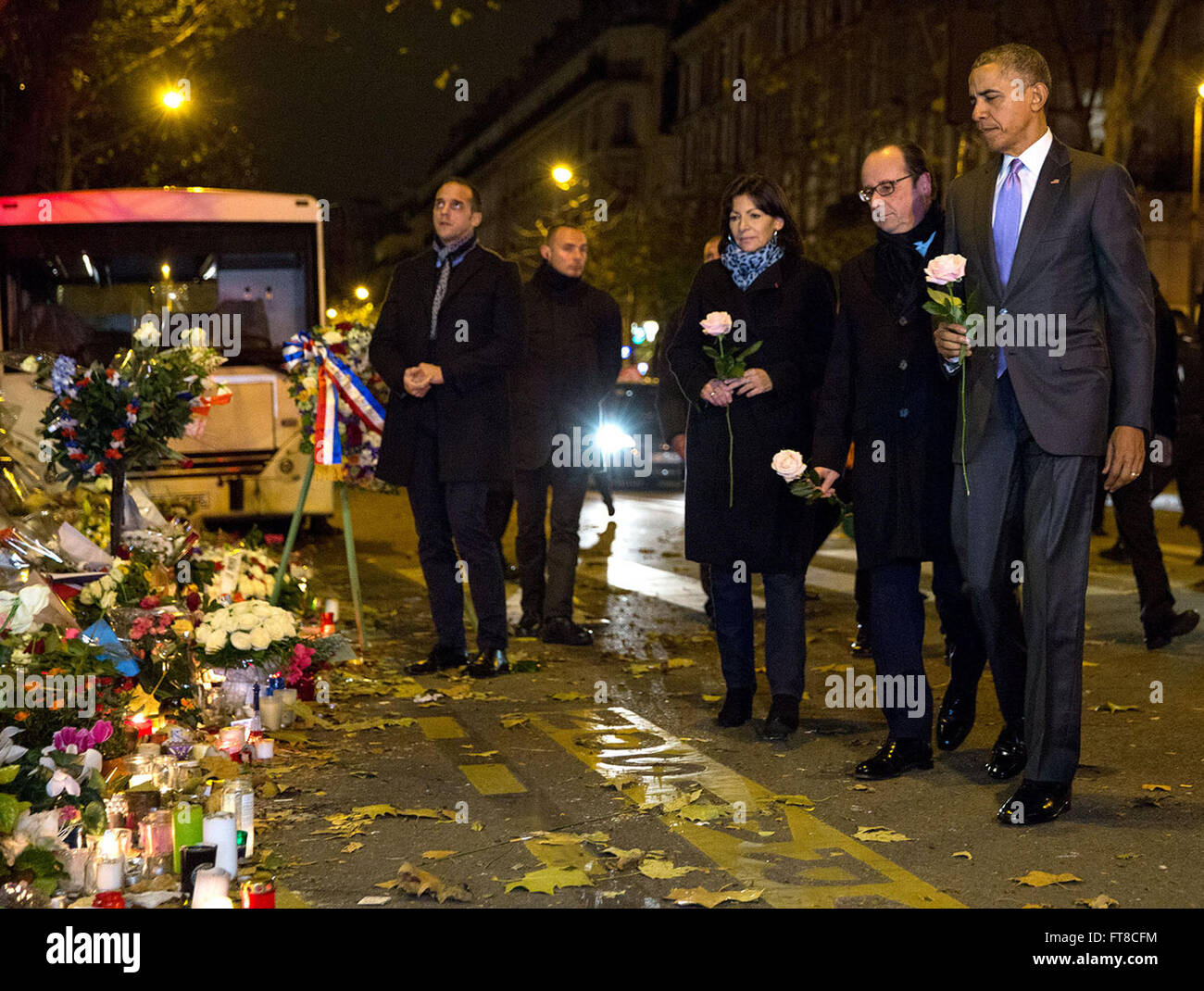 Nov. 30, 2015 'After arriving in France to attend the Climate Change Summit, the President, with French President François Hollande and Paris Mayor Anne Hidalgo, made an unannounced stop just after midnight at the memorial in front of le Batacian, the site of a Paris terrorist attack.' (Official White House Photo by Pete Souza) Stock Photo