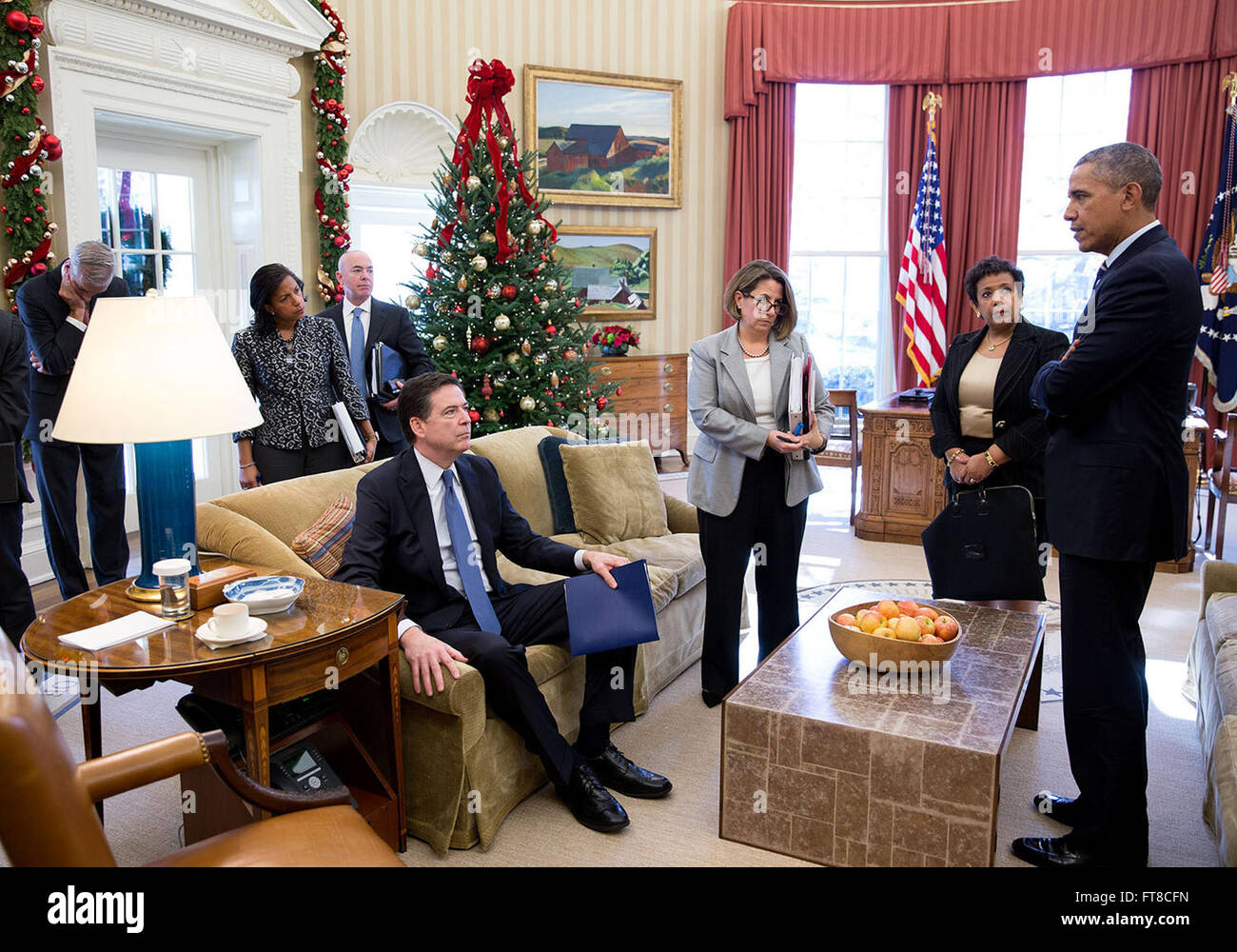 Dec. 3, 2015 'Following a meeting to discuss the latest information on the mass shootings in San Bernardino, Calif., the President has some last words with, from left, Chief of Staff Denis McDonough, National Security Advisor Susan E. Rice, FBI Director James Comey (seated on sofa), Alejandro N. Mayorkas, Deputy Secretary of Homeland Security, Lisa Monaco, Assistant to the President for Homeland Security and Counterterrorism, and Attorney General Loretta Lynch.' (Official White House Photo by Pete Souza) Stock Photo