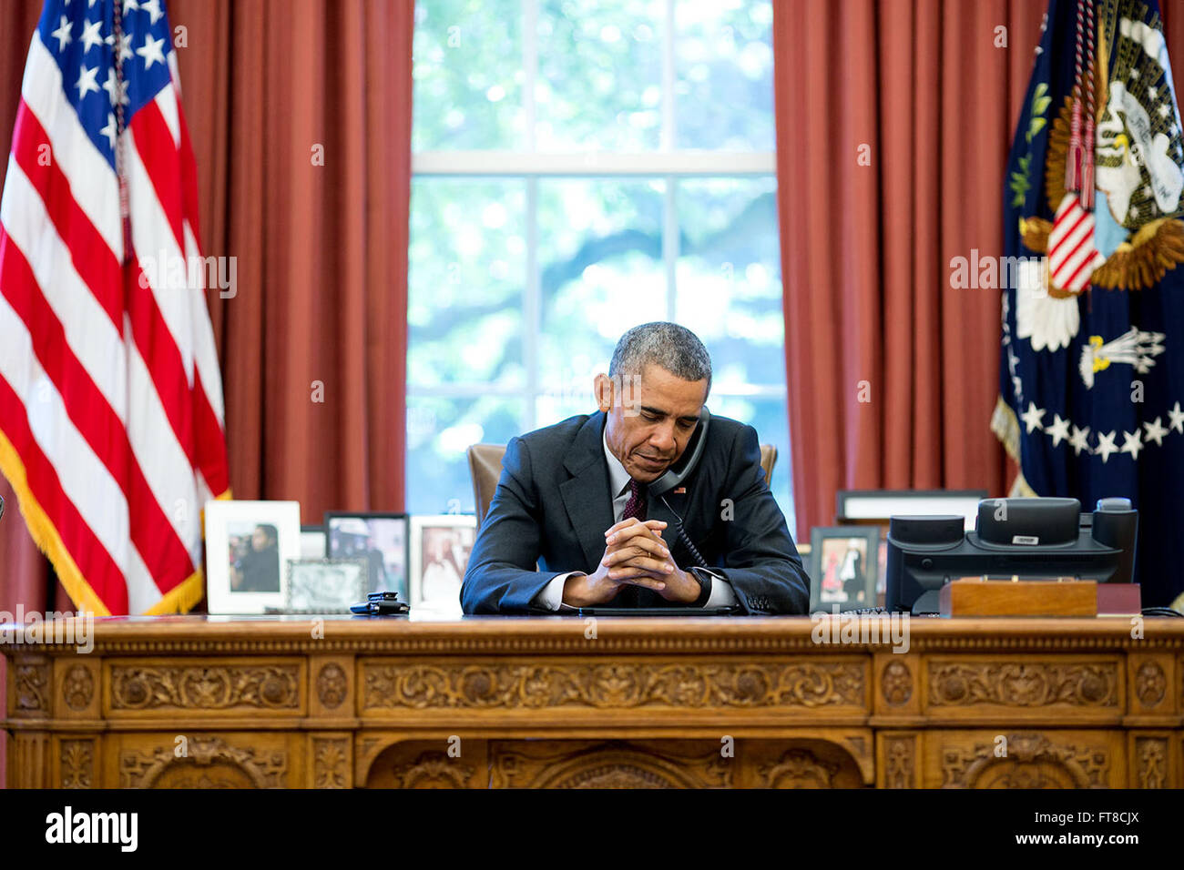 August 4, 2015 'On his birthday, the President listens to a prayer during a phone call with pastors.' (Official White House Photo by Pete Souza) Stock Photo