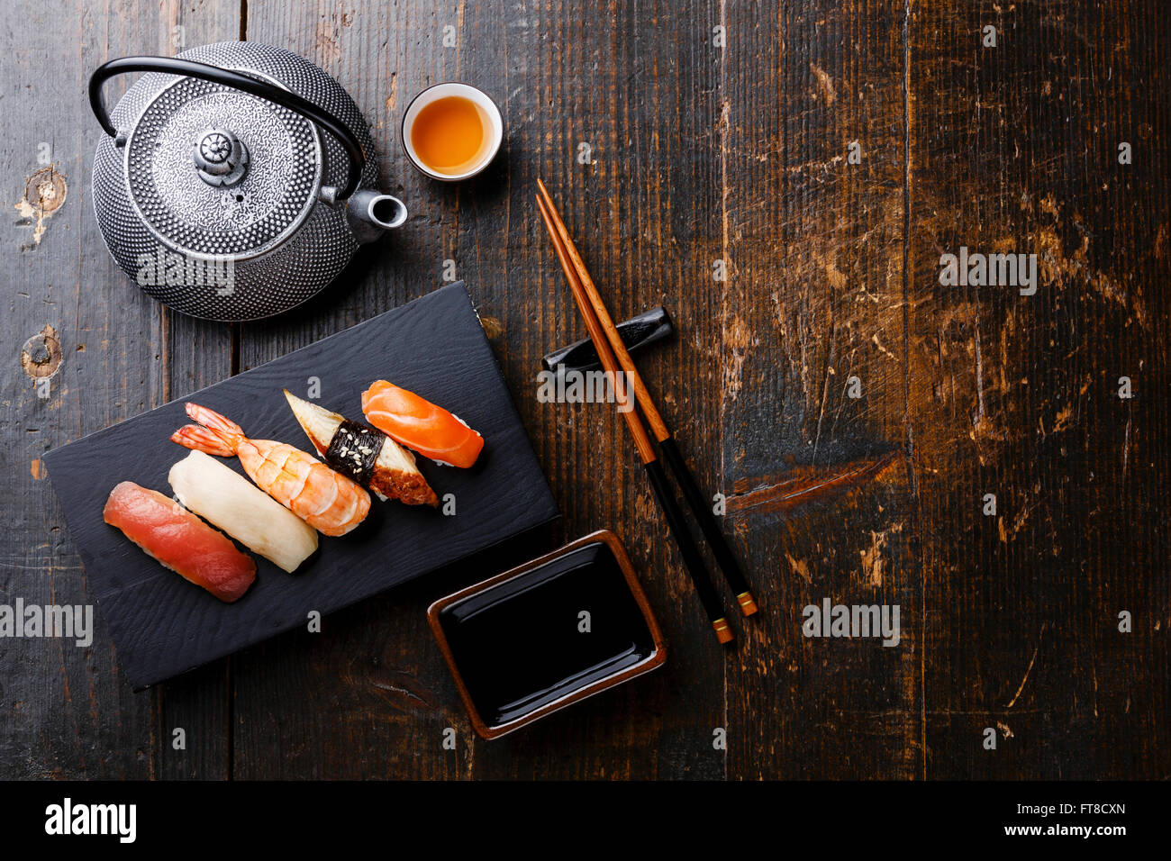 Nigiri sushi set and green tea on wooden table Stock Photo