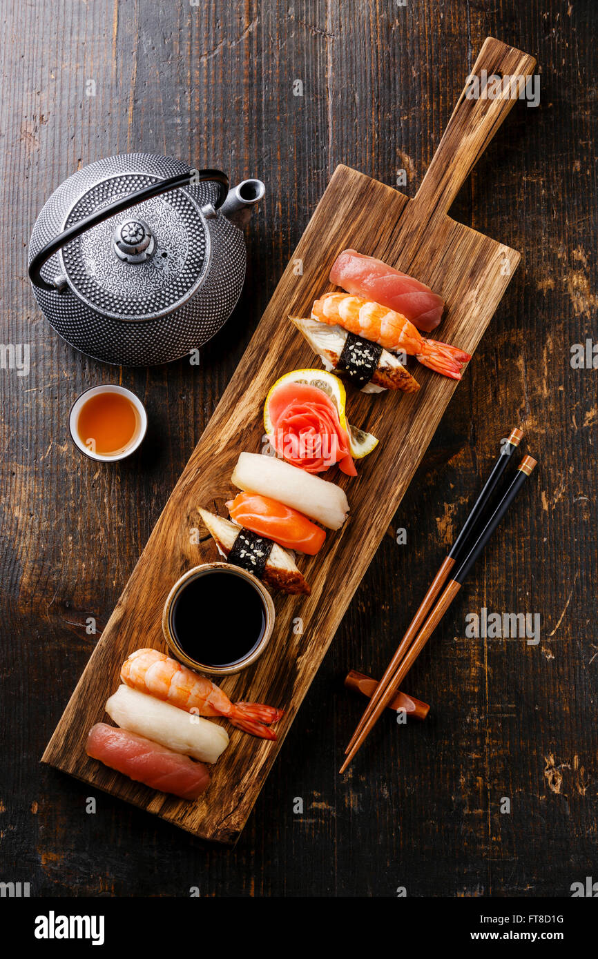Nigiri Sushi set on wooden serving board and green tea Stock Photo