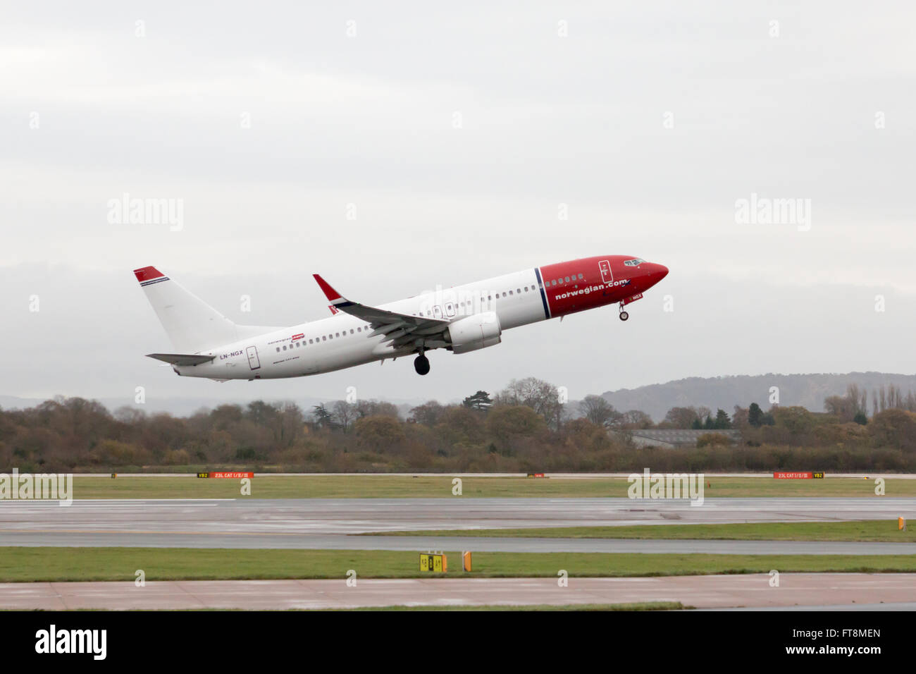 Norwegian Boeing 737-8JP narrow-body passenger plane (LN-NGX) taking off from Manchester International Airport runway. Stock Photo