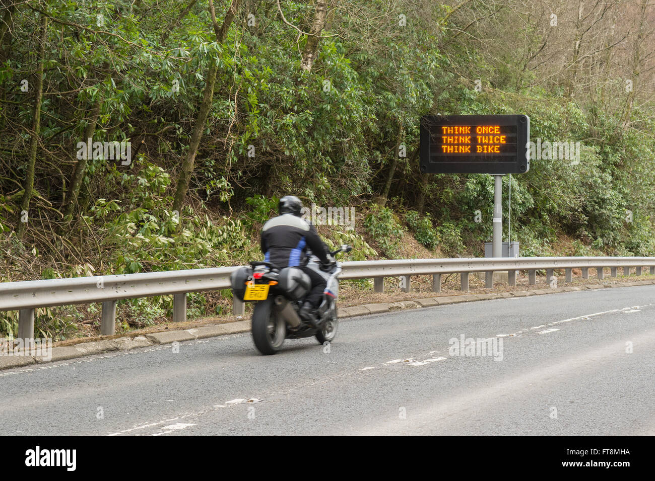 'Think Once Think Twice Think Bike' traffic warning sign on A82 road, Tarbet, Scotland, UK Stock Photo