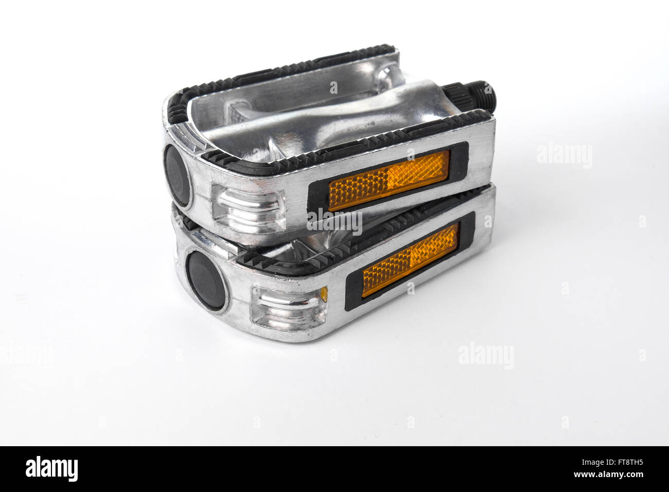 Two bicycle pedals of aluminum lying on top of each other Stock Photo