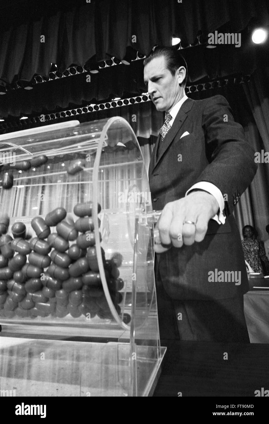 Vietnam Draft. Curtis W. Tarr, director of the Selective Service System, making the draw at the annual draft lottery, Commerce Department Auditorium, Washington DC, February 1972. Stock Photo