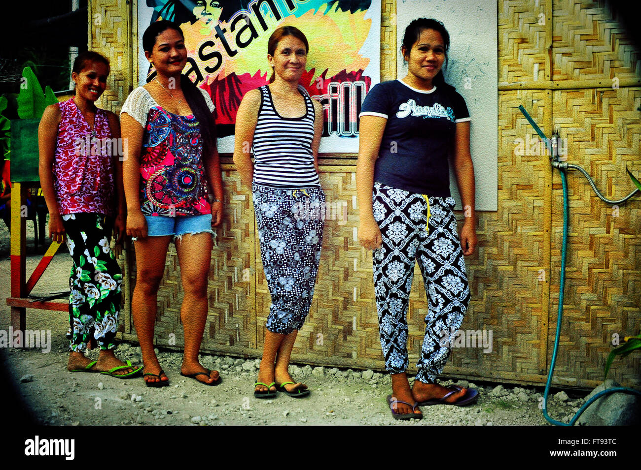 Filipinas at work at the Rastaman Grill, Siquijor Island, Philippines. Stock Photo