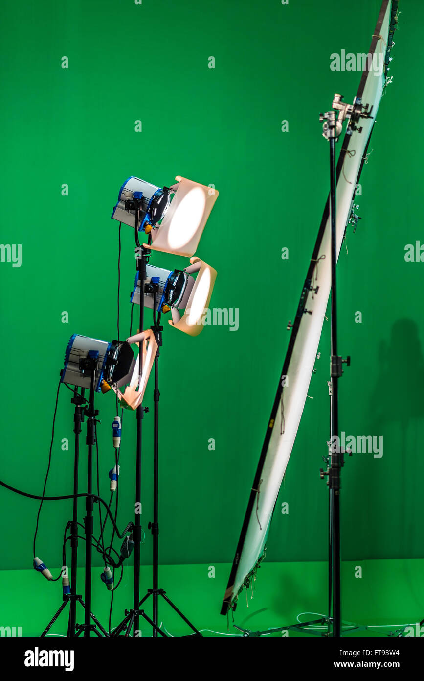 Three light projectors with diffusion filters are shining through a big diffusion frame. There is a chroma background behind the lights. Stock Photo