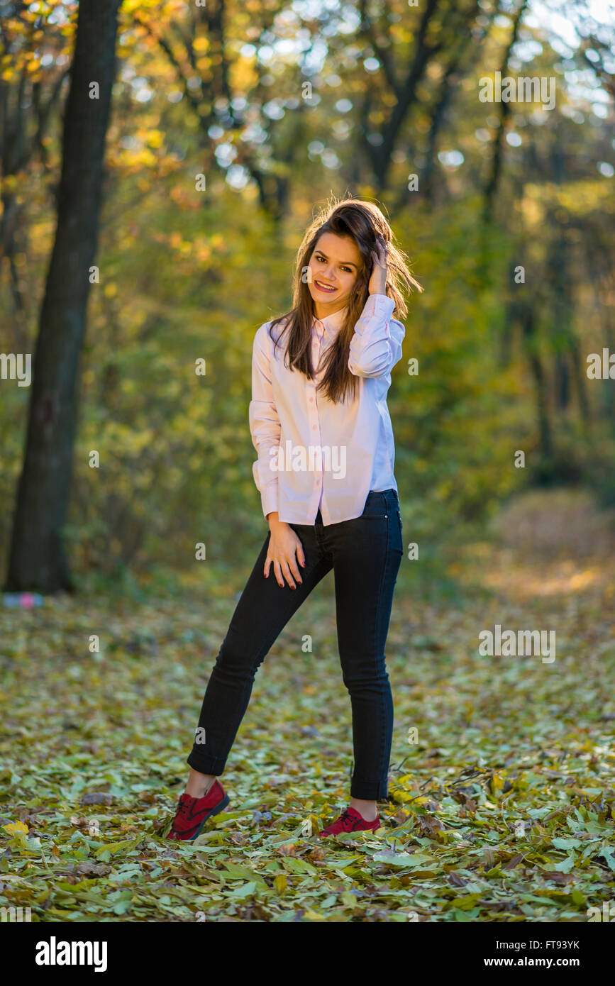 Positive Girl in Jeans, T-shirt and Stilettos Posing Near the Wall Stock  Photo - Image of hair, hold: 190579440