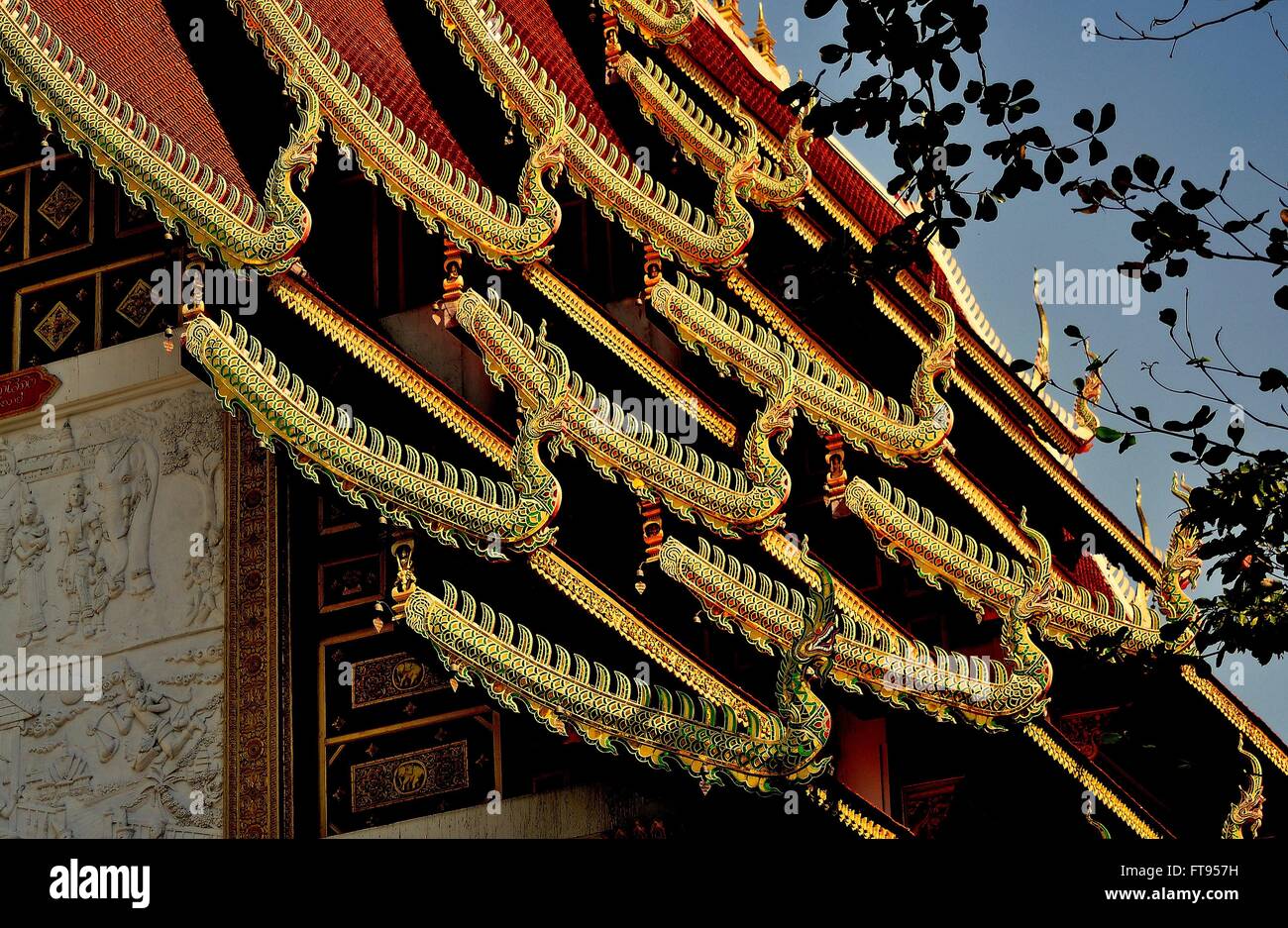 Chiang Mai, Thailand :  Ornate interlocking roofs with gilded dragon figures at Wat Ku Tao Stock Photo