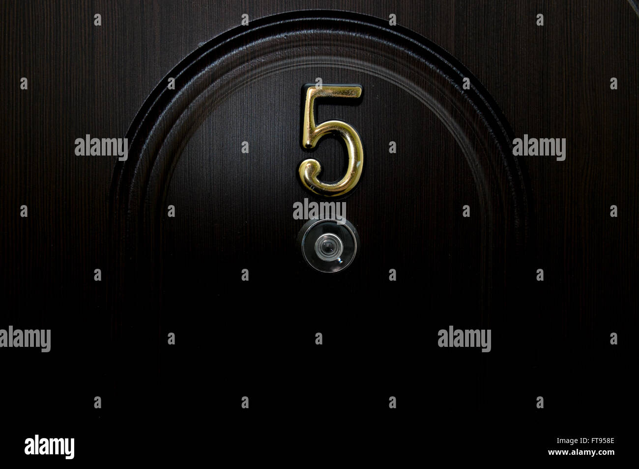 The number five and peephole on the front door Stock Photo