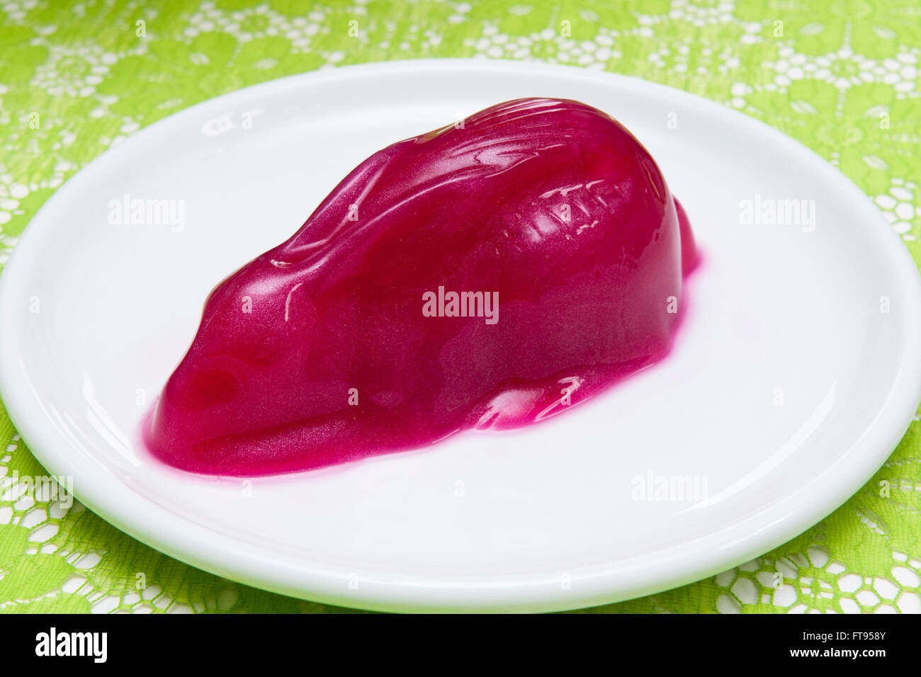 A raspberry glitter jelly Easter rabbit on a white plate Stock Photo