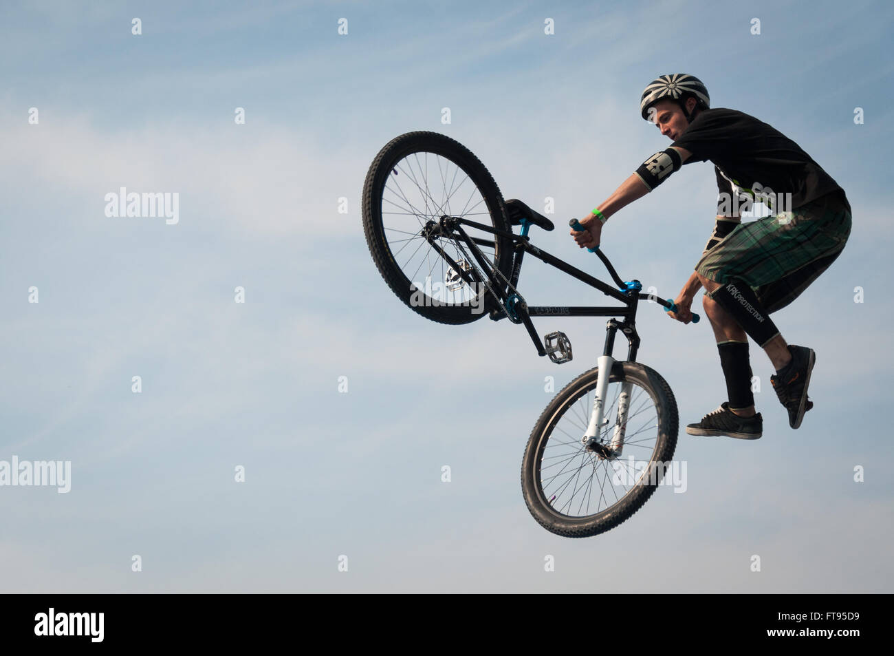 Biker with BMX bike jumping into the air performing stunt dirt jumping